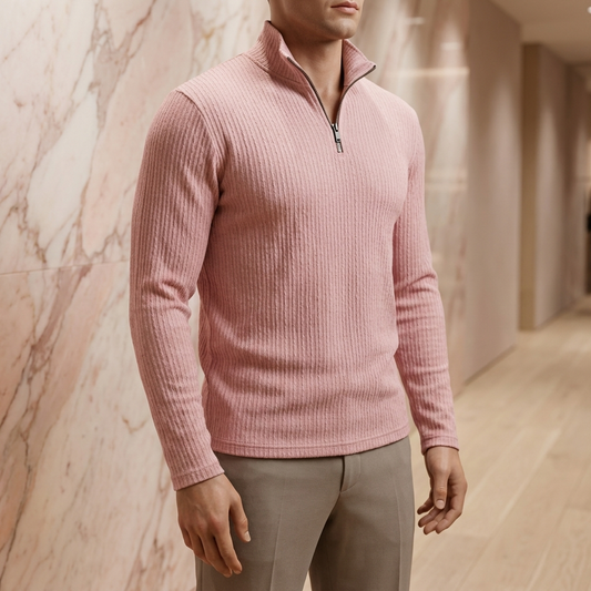 Men's ribbed quarter-zip pullover in lotus pink, on a boutique display mannequin against a rose marble wall and pale oak floor