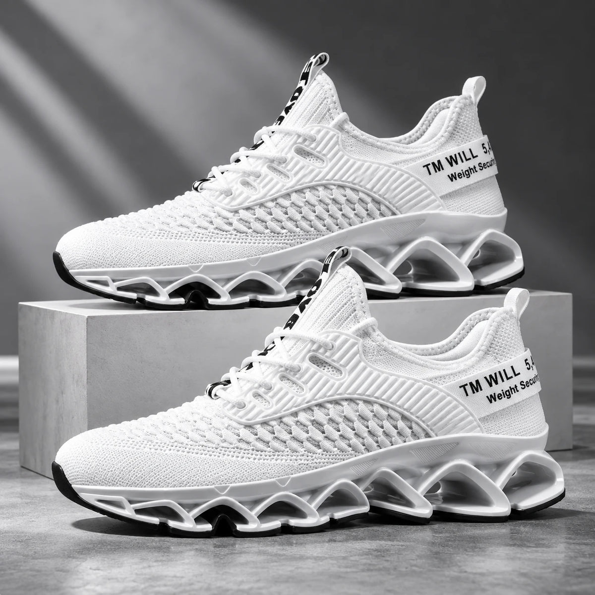 White men's mesh running shoes with blade sole on a grey studio background